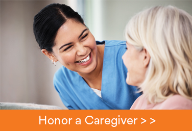 nurse smiling at patient with honor a caregiver text